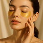 Golden collagen under-eye patches catching the light on luminous skin